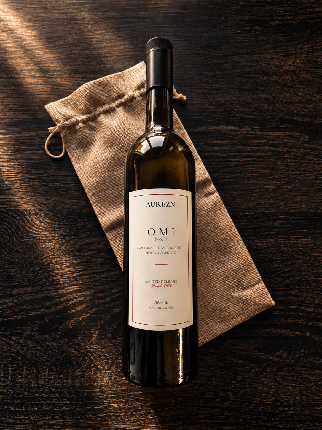 OMI No. 1 bottle beside its woven pouch on a dark wooden surface